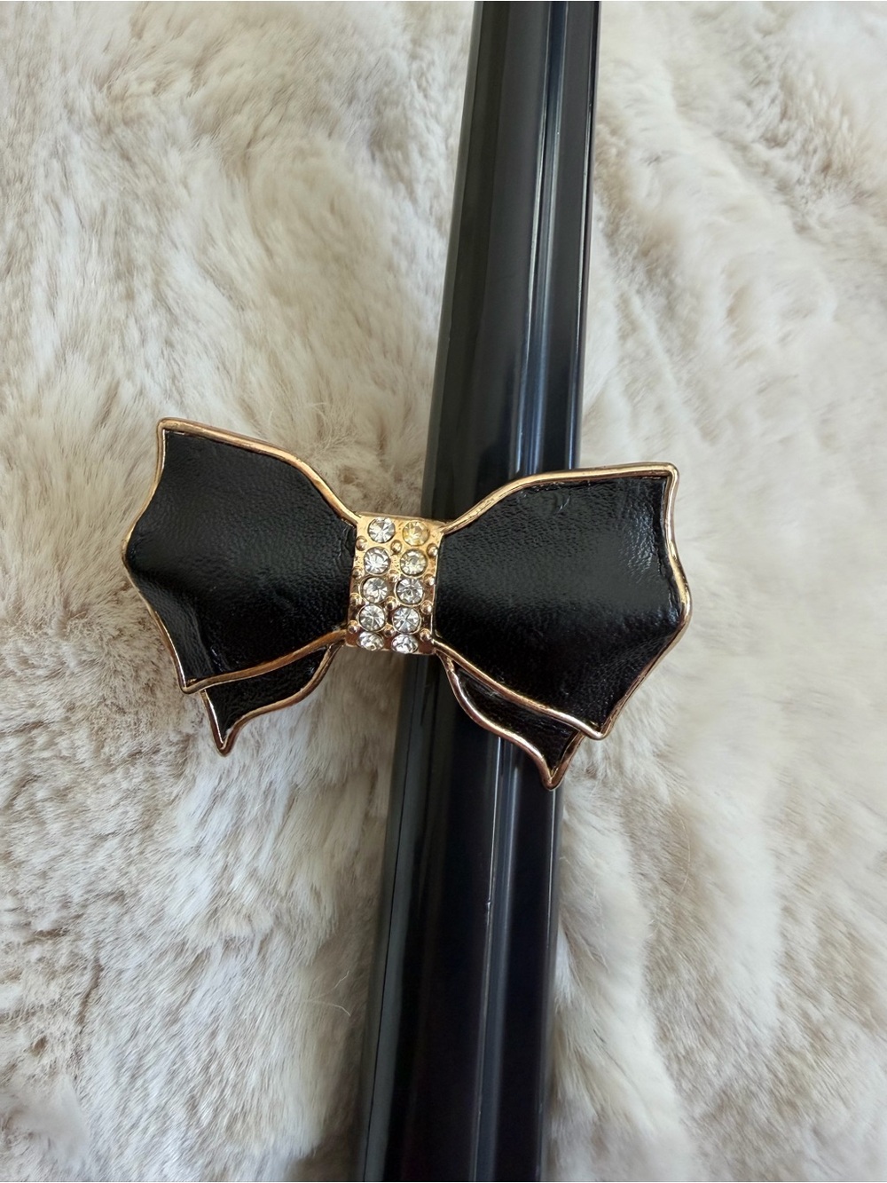 Leather toned 2 finger gold toned bow ring